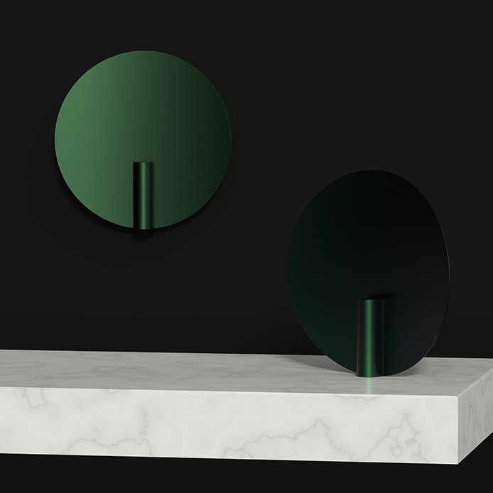 Two dark green nimbus vases, one sitting on a marble plinth, the other on a wall